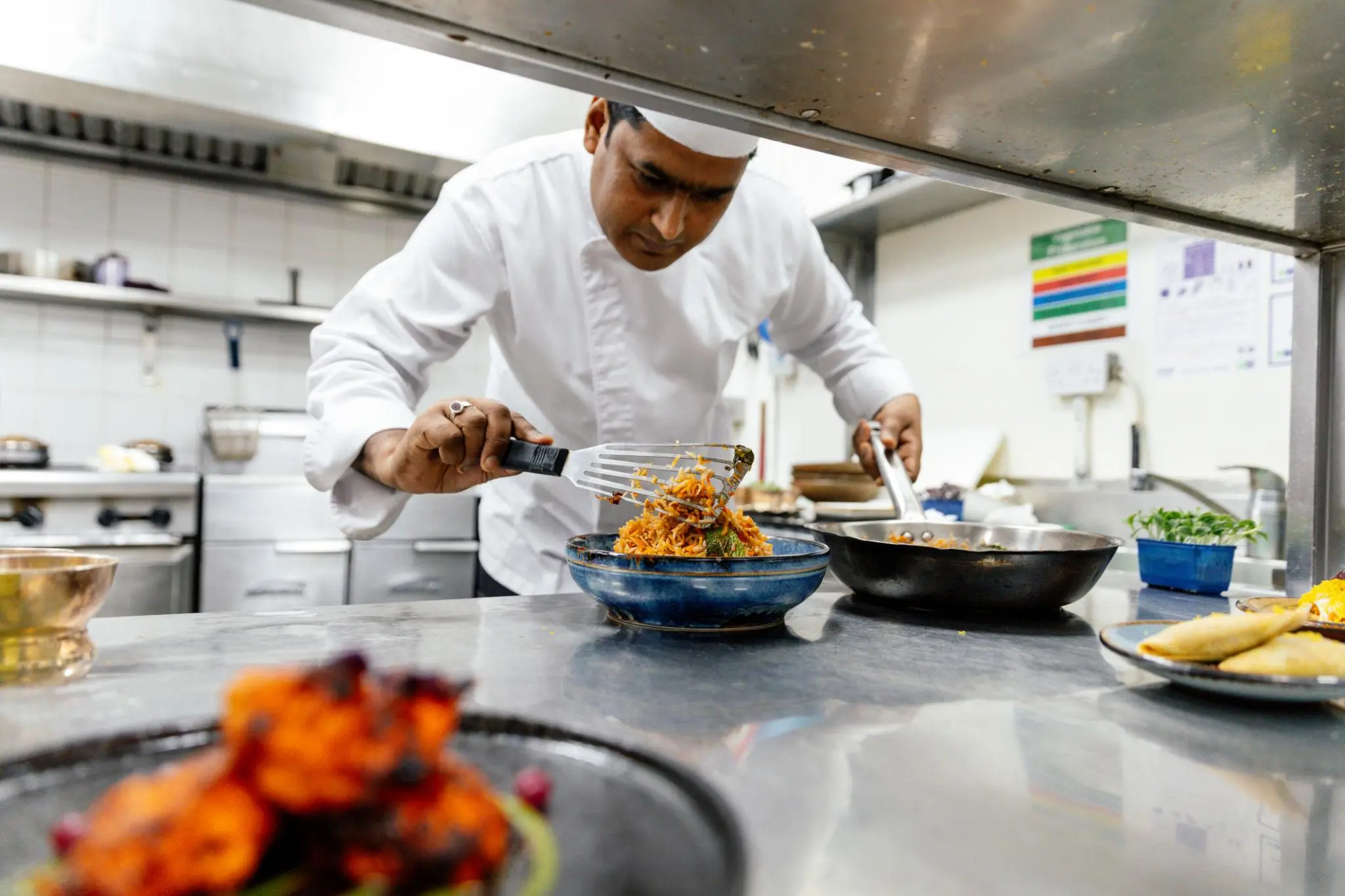 Chef preparing authentic Indian cuisine at Flavors Indian Cuisine